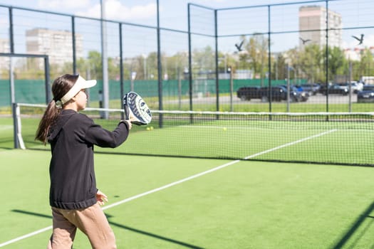 Ukraine Kyiv, April 20 2024. happy pretty girl practicing paddle sport on the paddle court. High quality photo