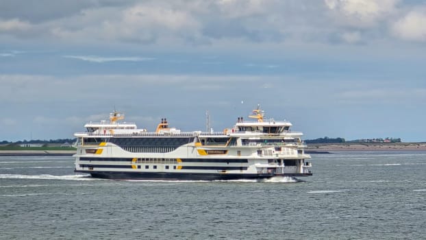 Texel Netherlands 12 May 2024,, A grand ferry glides gracefully across the waters near Texel, Netherlands, carrying passengers on a scenic journey.