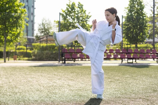 young girl in a white kimono, karate. High quality photo