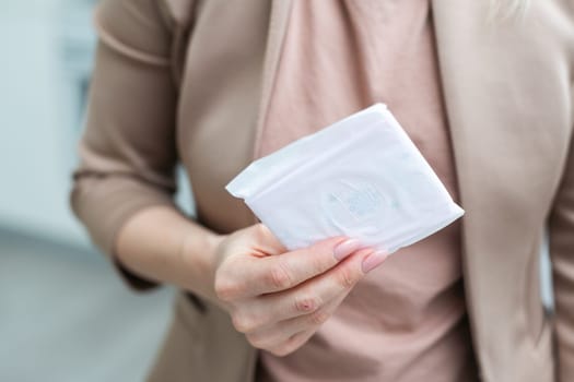 woman wearing a colored shirt holding a sanitary pad. High quality photo
