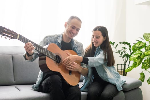 Guitar teacher teaching the little girl. High quality photo