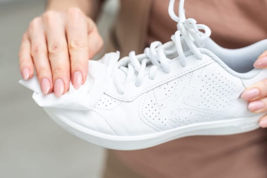 Cleaning white sneaker with cloth. High quality photo