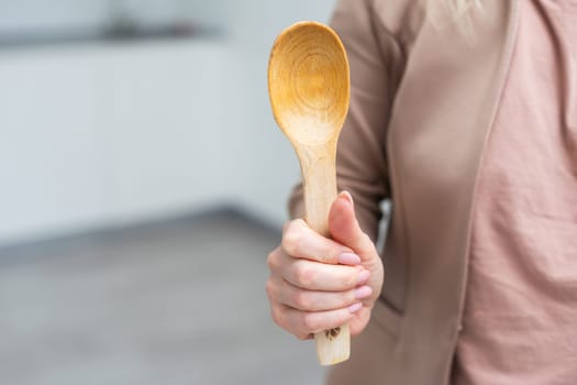 Wooden spoon in hand isolate. High quality photo