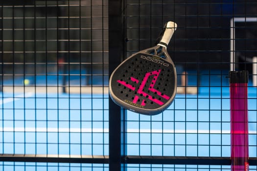 Ukraine Kyiv, April 02 2024. paddle tennis racket and balls on the blue paddle court. High quality photo