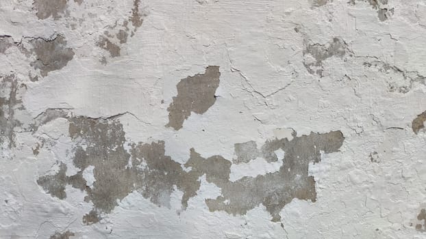 Old plaster. Background, texture. Close-up of a crumbling plaster wall revealing layers and texture