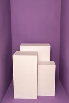 Three white rectangular boxes against purple background. Product photography mockup. High quality photo