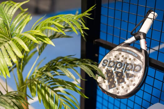 Kyiv, Ukraine. March 22, 2024 paddle tennis objects in court, racket, balls and fences outdoors, focus on fence. High quality photo