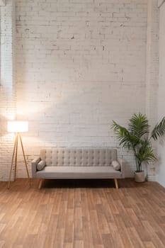 Sofa over white brick wall copy space. High quality photo