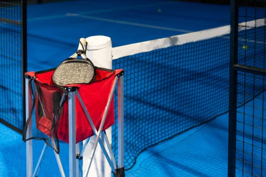 Paddle ball on racket. Yellow paddle ball laying near racket. High quality photo