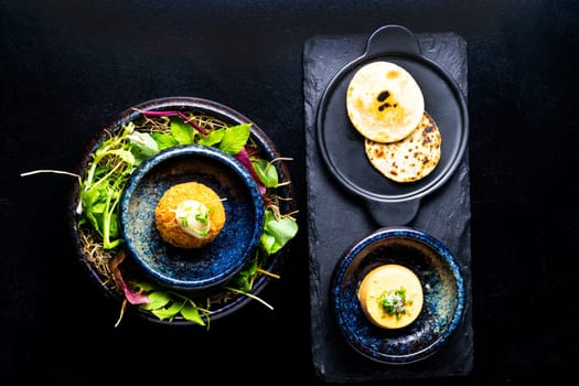 Closeup of some spanish croquettes in bed of lettuce served as tapas