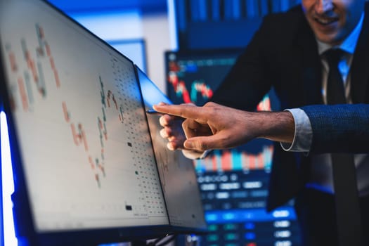 Stock traders pointing highest stock market on dynamic valued analysis on monitor real time screen, cooperating business investment in financial company to plan successful stock exchange. Sellable.