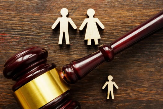 Family figures and a gavel. Adoption and guardianship concept.