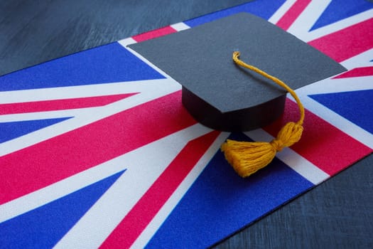 The flag of Great Britain and the graduation cap as symbol of the learning on it.