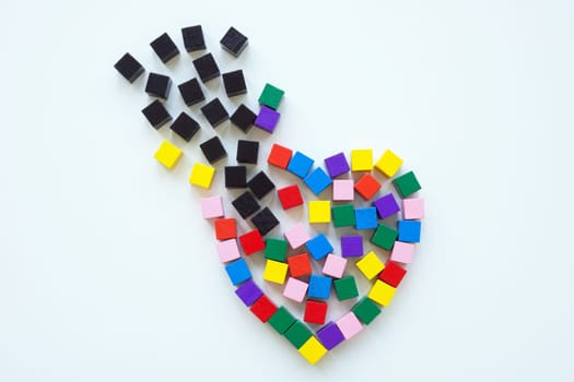 Heart made of colored cubes and black ones as concept of stress, worries and despair.