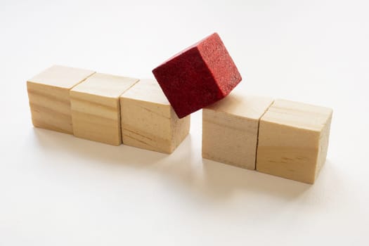 A line of cubes and separate red one. Concept of personnel management and dismissal of a bad employee.