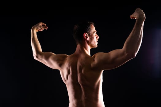 Portrait of man, bodybuilder and bicep flex in a studio, background and exercise for muscular power.