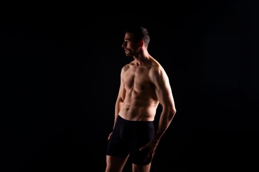 Portrait of man, bodybuilder and bicep flex in a studio, background and exercise for muscular power.