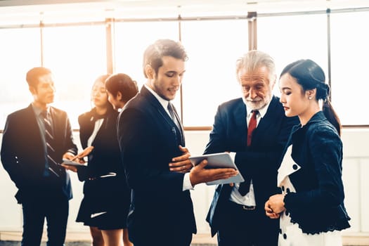 Many young businessmen and businesswomen in group meeting standing at conference hall in office. Multicultural company organization unity and support. Concept of partnership and human resources. uds