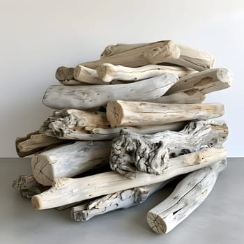 A stack of driftwood serves as a unique centerpiece on the table, showcasing the natural beauty of wood combined with dishware and serveware