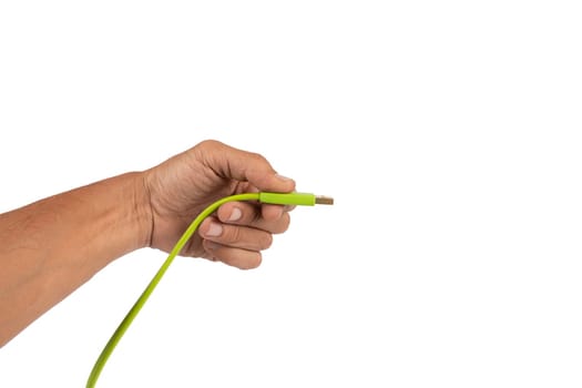 Black male hand holding a green USB cable isolated on white background. High quality photo