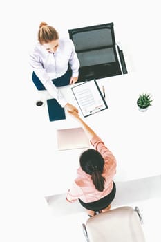 Two young business women in meeting at office table for job application and business agreement. Recruitment and human resources concept. uds