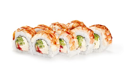 Delicious Japanese sushi rolls with filling of cucumber, tobiko roe, and creamy cheese, topped with shrimp and drizzle of spicy sauce, isolated on white background