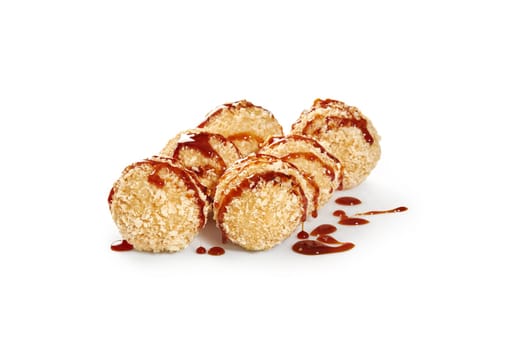 Crispy tempura rice balls with salmon and cream cheese, coated with panko breadcrumbs drizzled with tangy unagi sauce, isolated on white background. Japanese style snack