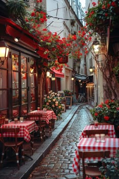 A red and white checkered table is set up on a cobblestone street. The table is surrounded by chairs and potted plants. The scene is reminiscent of a cozy outdoor cafe, with the red
