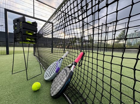 Background of padel racket and ball on artificial grass floor in outdoor court. Top view. High quality photo