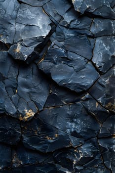 An upclose view of a black bedrock with shimmering gold spots resembling an electric blue pattern on liquid flooring