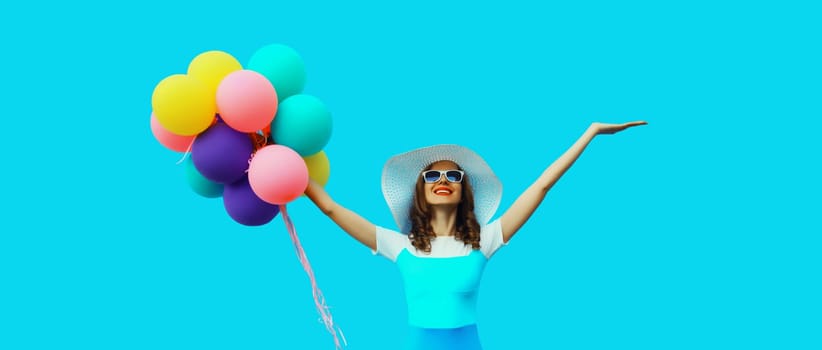 Summer, holiday, celebration, happy cheerful young woman with bright colorful balloons having fun on blue background