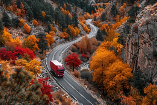 A red truck is seen driving down a road surrounded by lush green trees.