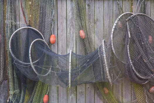 Old fishing net on a wooden fence. Background.