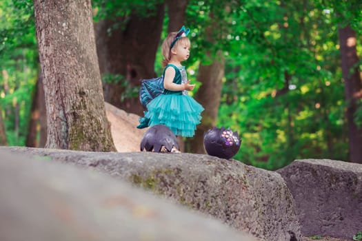 adorable baby in a dragon costume that has just hatched from an egg.