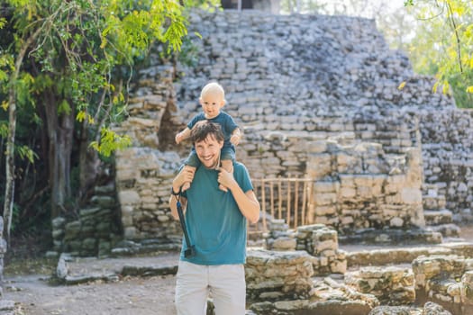 Dad and son tourists at Coba, Mexico. Ancient mayan city in Mexico. Coba is an archaeological area and a famous landmark of Yucatan Peninsula. Cloudy sky over a pyramid in Mexico.