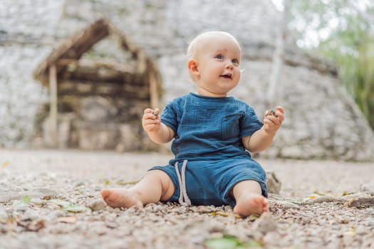 Baby tourist at Coba, Mexico. Ancient mayan city in Mexico. Coba is an archaeological area and a famous landmark of Yucatan Peninsula. Cloudy sky over a pyramid in Mexico.