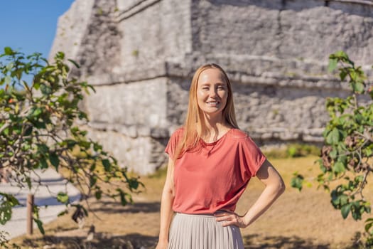 Woman tourist enjoying the view Pre-Columbian Mayan walled city of Tulum, Quintana Roo, Mexico, North America, Tulum, Mexico. El Castillo - castle the Mayan city of Tulum main temple.