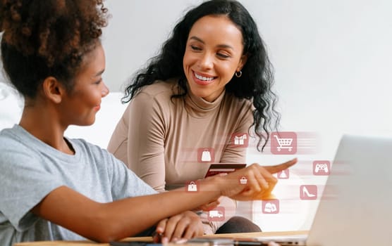 Elegant customer wearing gray shirt point laptop consulting smart brown shirt user holding credit card watching while open e-commerce application use cashless technology shopping inventory. Cybercash.