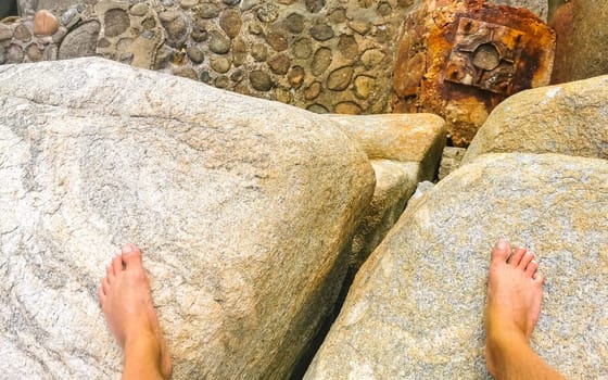 Walking on the pavement rocks stones feet barefoot in Zicatela Puerto Escondido Oaxaca Mexico.