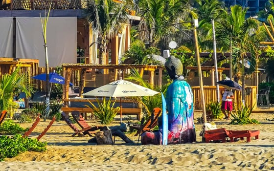 Restaurant restaurants bar bars shops hotels palms palm trees and promenades on the beach in Zicatela Puerto Escondido Oaxaca Mexico.