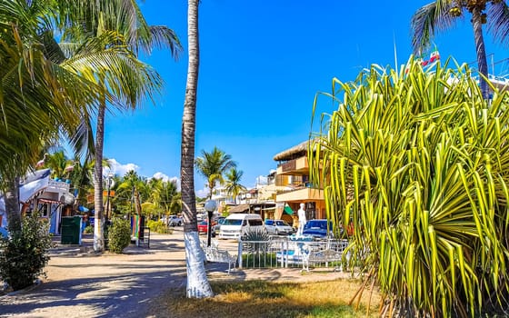 Restaurant restaurants bar bars shops hotels palms palm trees and promenades on the beach in Zicatela Puerto Escondido Oaxaca Mexico.