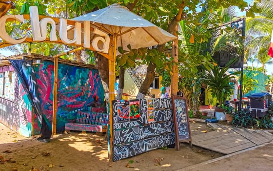 Restaurant restaurants bar bars shops hotels palms palm trees and promenades on the beach in Zicatela Puerto Escondido Oaxaca Mexico.