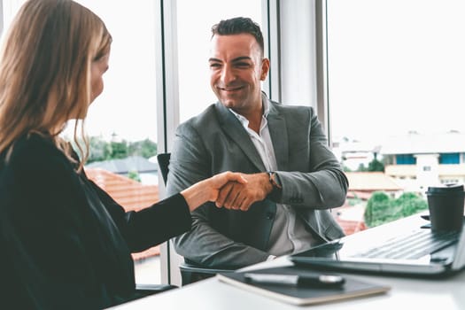 Businessman executive handshake with businesswoman worker in modern workplace office. People corporate business deals concept. uds