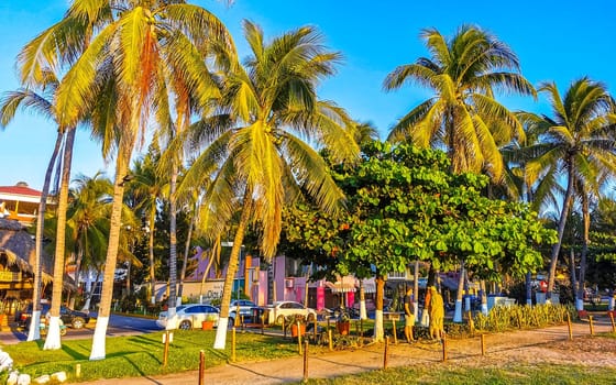 Restaurant restaurants bar bars shops hotels palms palm trees and promenades on the beach in Zicatela Puerto Escondido Oaxaca Mexico.