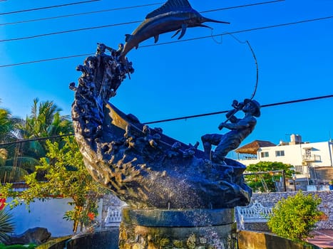 Statue sculpture angler with fish swordfish fountain in Zicatela Puerto Escondido Oaxaca Mexico.