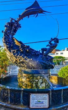 Statue sculpture angler with fish swordfish fountain in Zicatela Puerto Escondido Oaxaca Mexico.