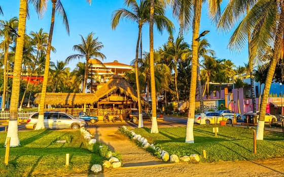 Restaurant restaurants bar bars shops hotels palms palm trees and promenades on the beach in Zicatela Puerto Escondido Oaxaca Mexico.