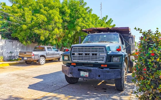 Mexican tipper dumper dump trucks truck cargo transporter delivery cars car vehicles in Puerto Escondido Zicatela Oaxaca Mexico.