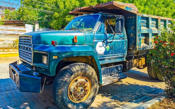 Mexican tipper dumper dump trucks truck cargo transporter delivery cars car vehicles in Puerto Escondido Zicatela Oaxaca Mexico.