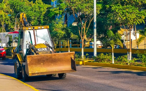 Yellow excavator with shovel in Zicatela Puerto Escondido Oaxaca Mexico.